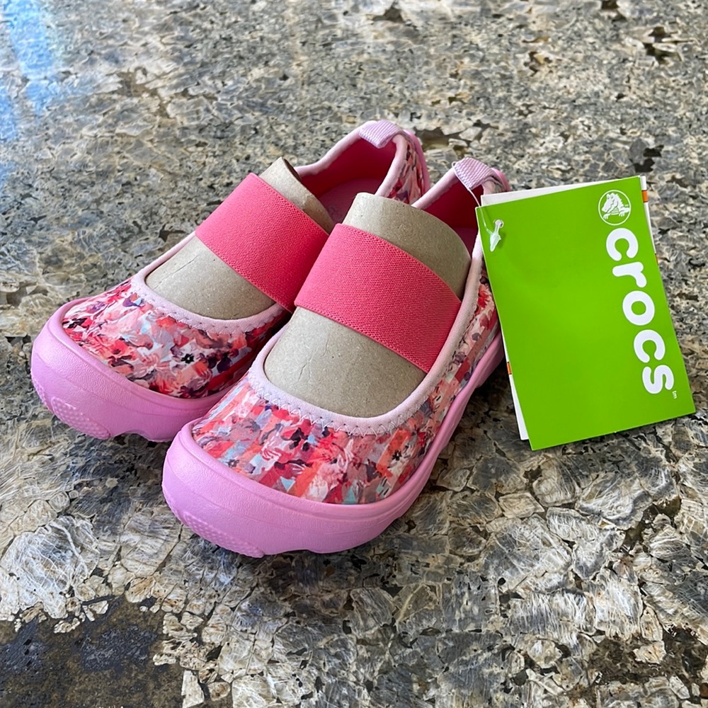 The base is croc water-proof material. The patterned part feels like neoprene.